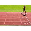 Runner on a running track finishing a race first (motion blurred image)