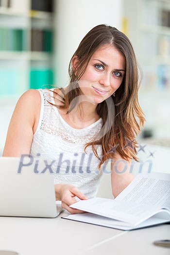 Pretty young college student in a library (shallow DOF; color toned image) Pretty young college student in a library (shallow DOF; color toned image)