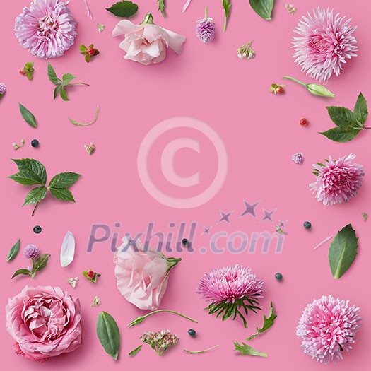 Pink flowers frame on pink background with copy space for greeting message. Pink flowers frame on pink background with copy space for greeting message.