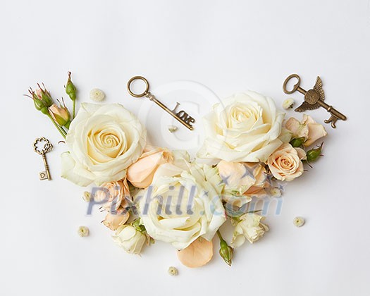 Vintage keys with beige roses on the background, Flat lay. Vintage keys with beige roses on the background, Flat lay.