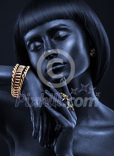 Fashion portrait of a dark-skinned beautiful girl with jewerly. Black Beauty face. Picture taken in the studio on a black background. Fashion portrait of a dark-skinned beautiful girl with jewerly. Black Beauty face. Picture taken in the studio on a black background.