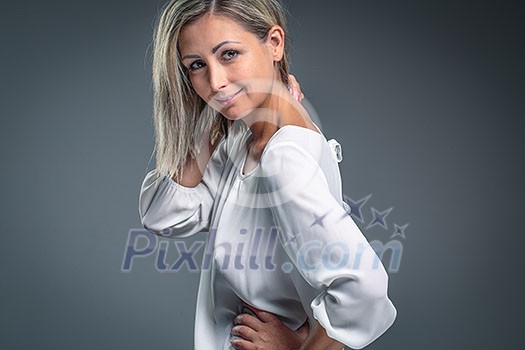 Gorgeous young woman against grey background Gorgeous young woman against grey background