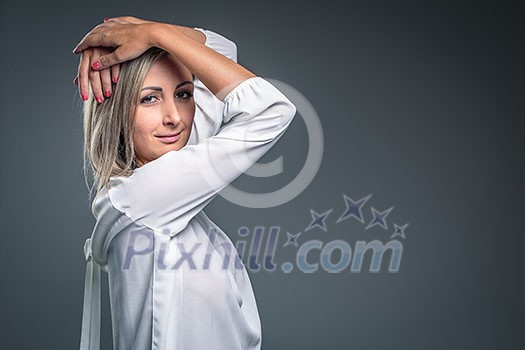 Gorgeous young woman against grey background Gorgeous young woman against grey background