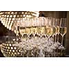 Champagne flutes on shiny, glassy background with lovely blurred lights in the background