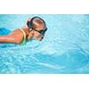 Pretty female swimmer in a pool, getting her daily dose of exercise without stressing her joints