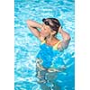 Pretty female swimmer in a pool, getting her daily dose of exercise without stressing her joints