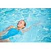 Pretty female swimmer in a pool, getting her daily dose of exercise without stressing her joints