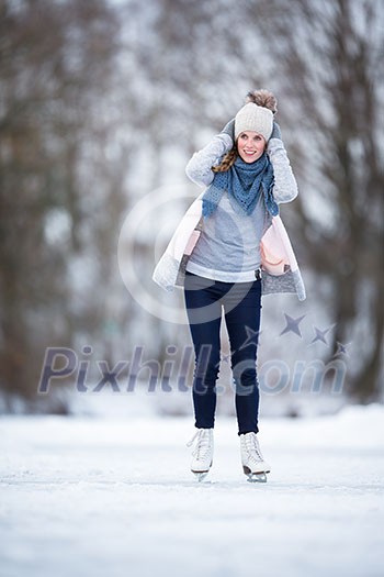 Young woman ice skating outdoors on a pond on a freezing winter day (color toned image; motion blurred image) Young woman ice skating outdoors on a pond on a freezing winter day (color toned image; motion blurred image)