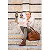 Gorgeous female tourist with a map discovering a foreign city (shallow DOF; color toned image)