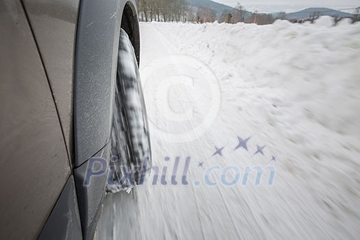 Car with winter tires on a slippery, snowy road - motion blur techinque used to convey movement, speed of the car Car with winter tires on a slippery, snowy road - motion blur techinque used to convey movement, speed of the car