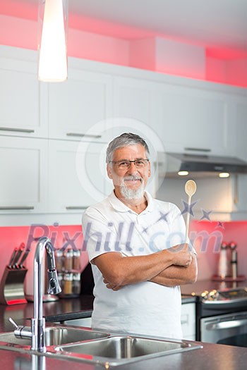 Senior man standing in his renovated, modern kitchen, Senior man standing in his renovated, modern kitchen,