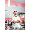 Senior man standing in his renovated, modern kitchen,