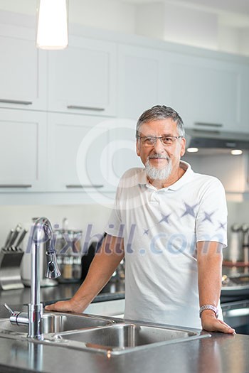 Senior man standing in his renovated, modern kitchen, Senior man standing in his renovated, modern kitchen,