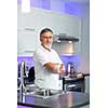 Senior man standing in his renovated, modern kitchen,