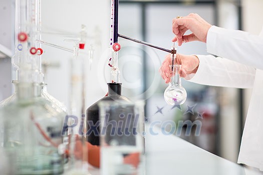 Lab worker's hands while at work at a research center in a lab, carrying out an experiment (shallow DOF; color toned image) Lab worker's hands while at work at a research center in a lab, carrying out an experiment (shallow DOF; color toned image)