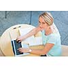 Pretty young female student with a laptop computer on college/university campus