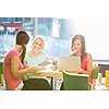 Group of university students studying hard for an exam in a lovely bright sunlit studying room/library