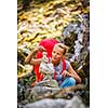 Pretty, young female hiker walking in high mountains (shallow DOF)