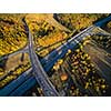 Aerial view of a highway amid fields with cars on it