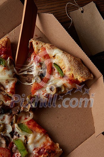 Hot Supreme Pizza with Pepperoni Peppers and mushrooms in the box, flat lay Hot Supreme Pizza with Pepperoni Peppers and mushrooms in the box, flat lay