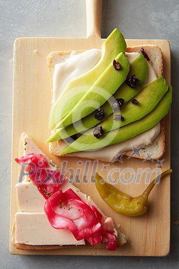 delicious avocado sandwich on a wooden board delicious avocado sandwich on a wooden board