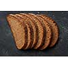 Many slices of delicious and fresh bread represented one after another isolated on black background. Slices of grain bread. Bread concept.