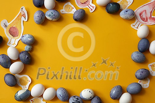 frame of eggs of different color with painted chicken on a yellow background