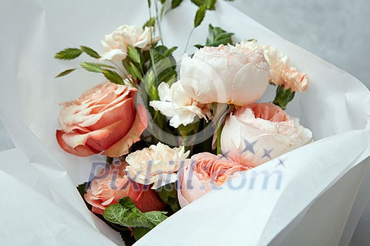 Woman's Day concept. Closeup of bouquet of roses for giving as gift or present. Bouquet of roses represented in glass vase over white background. Woman's Day concept. Closeup of bouquet of roses for giving as gift or present. Bouquet of roses represented in glass vase over white background.