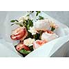 Woman's Day concept. Closeup of bouquet of roses for giving as gift or present. Bouquet of roses represented in glass vase over white background.
