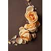 Decoration of orange flowers and petals over brown background