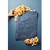Female hand decorating blank sheet of paper with flowers. Empty frame for text