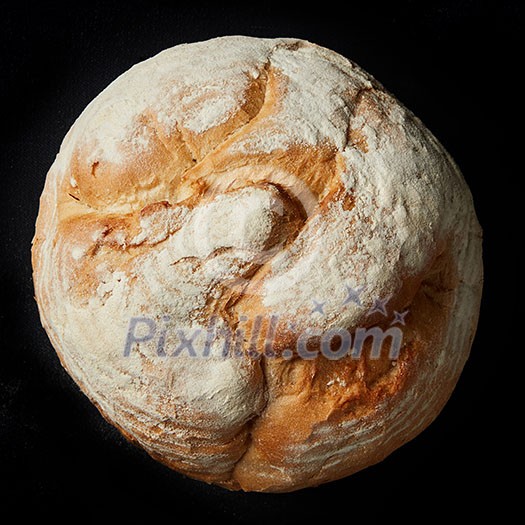 Round loaf of home made bread on black background Round loaf of home made bread on black background