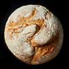 Round loaf of home made bread on black background