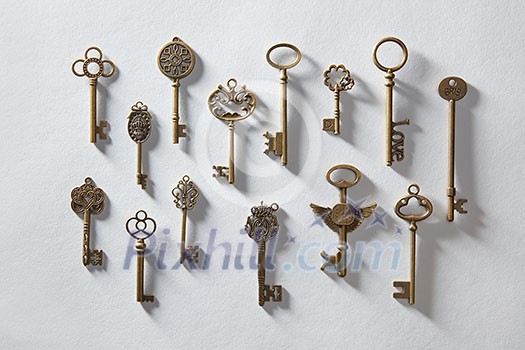 Vintage or antique door keys on white paper Vintage or antique door keys on white paper