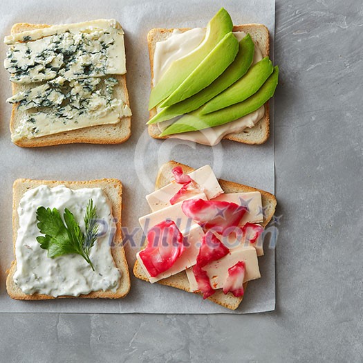 Top view of Breakfast toasts with cheese on paper Top view of Breakfast toasts with cheese on paper