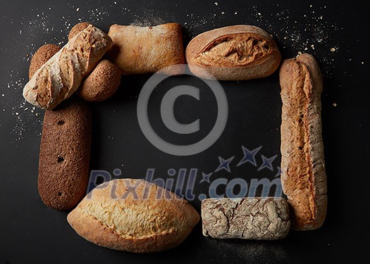 Baking and cooking concept background. Top view of different kinds of bread represented in form of frame. Copy space in middle may be used for your ideas, emotions. Baking and cooking concept background. Top view of different kinds of bread represented in form of frame. Copy space in middle may be used for your ideas, emotions.