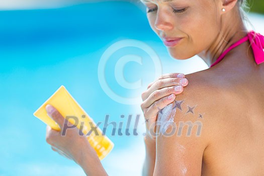 Attractive, young woman with healthy skin applying suncream by a pool (shallow DOF; color toned image) Attractive, young woman with healthy skin applying suncream by a pool (shallow DOF; color toned image)