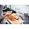 Young woman cooking in her modern kitchen (shallow DOF; color toned image)