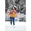 Young woman ice skating outdoors on a pond on a freezing winter day (color toned image; motion blurred image)