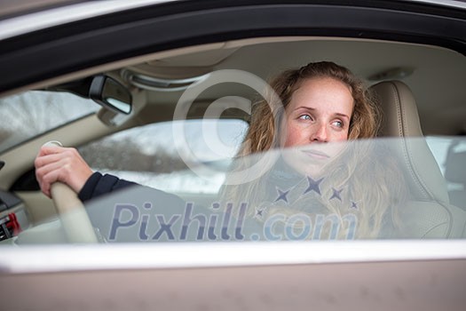 Pretty young woman driving her new car (shallow DOF; color toned image) Pretty young woman driving her new car (shallow DOF; color toned image)
