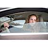 Pretty young woman driving her new car (shallow DOF; color toned image)