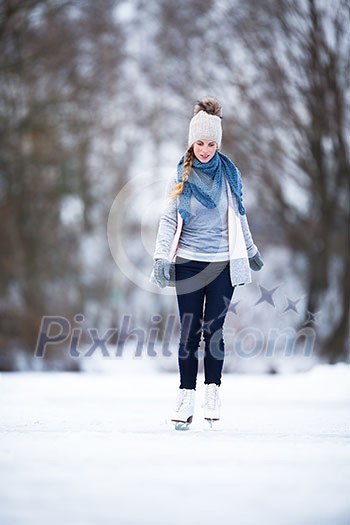 Young woman ice skating outdoors on a pond on a freezing winter day (color toned image; motion blurred image) Young woman ice skating outdoors on a pond on a freezing winter day (color toned image; motion blurred image)
