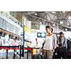 Young female passenger at the airport, about to check-in