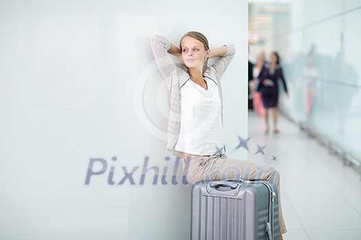 Young female passenger at the airport, about to check-in Young female passenger at the airport, about to check-in