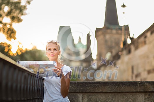 Pretty young female tourist studying a map, enjoying discovering a new city, looking excited (shallow DOF; color toned image) Pretty young female tourist studying a map, enjoying discovering a new city, looking excited (shallow DOF; color toned image)
