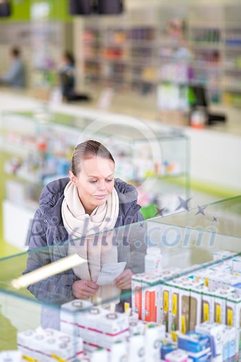Young woman looking for the right pills in a modern pharmacy (shallow DOF; color toned image) Young woman looking for the right pills in a modern pharmacy (shallow DOF; color toned image)