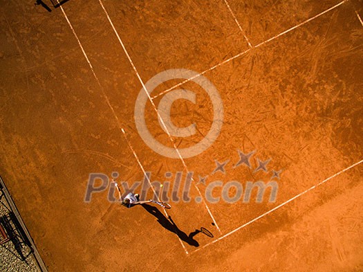 Female tennis player on the court. Wide angle view from above with plenty of copyspace Female tennis player on the court. Wide angle view from above with plenty of copyspace