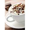 Cup of hot cocoa with shaved chocolate and whipped cream