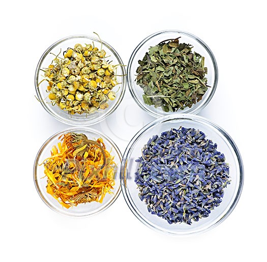 Bowls of dry medicinal herbs on white background from above Bowls of dry medicinal herbs on white background from above