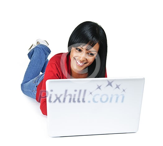 Smiling black woman typing on computer laying on floor Smiling black woman typing on computer laying on floor